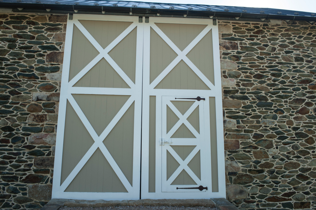  Barn doors incorporate smaller entry door. 