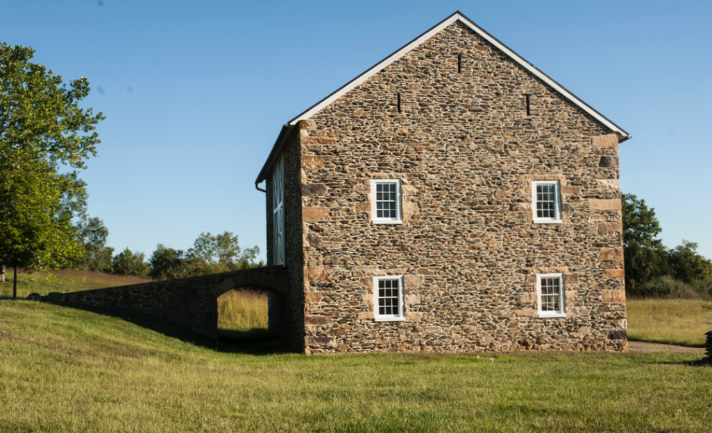  Period inspired barn features new windows set into custom frames of salvaged materials. 