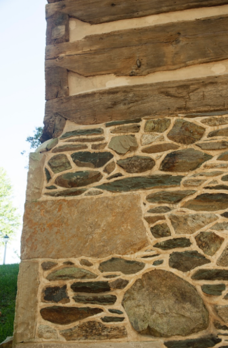  Corner stonework supports the structures logs, all notched at the corners. 