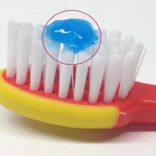 Child-sized portion of toothpaste (on child's brush)