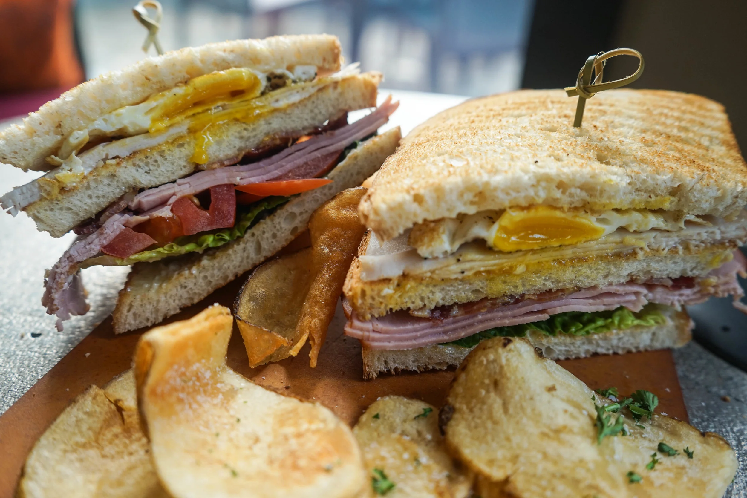 Club. green leaf. roma tomato. ham. turkey. fried egg. applewood smoked bacon.