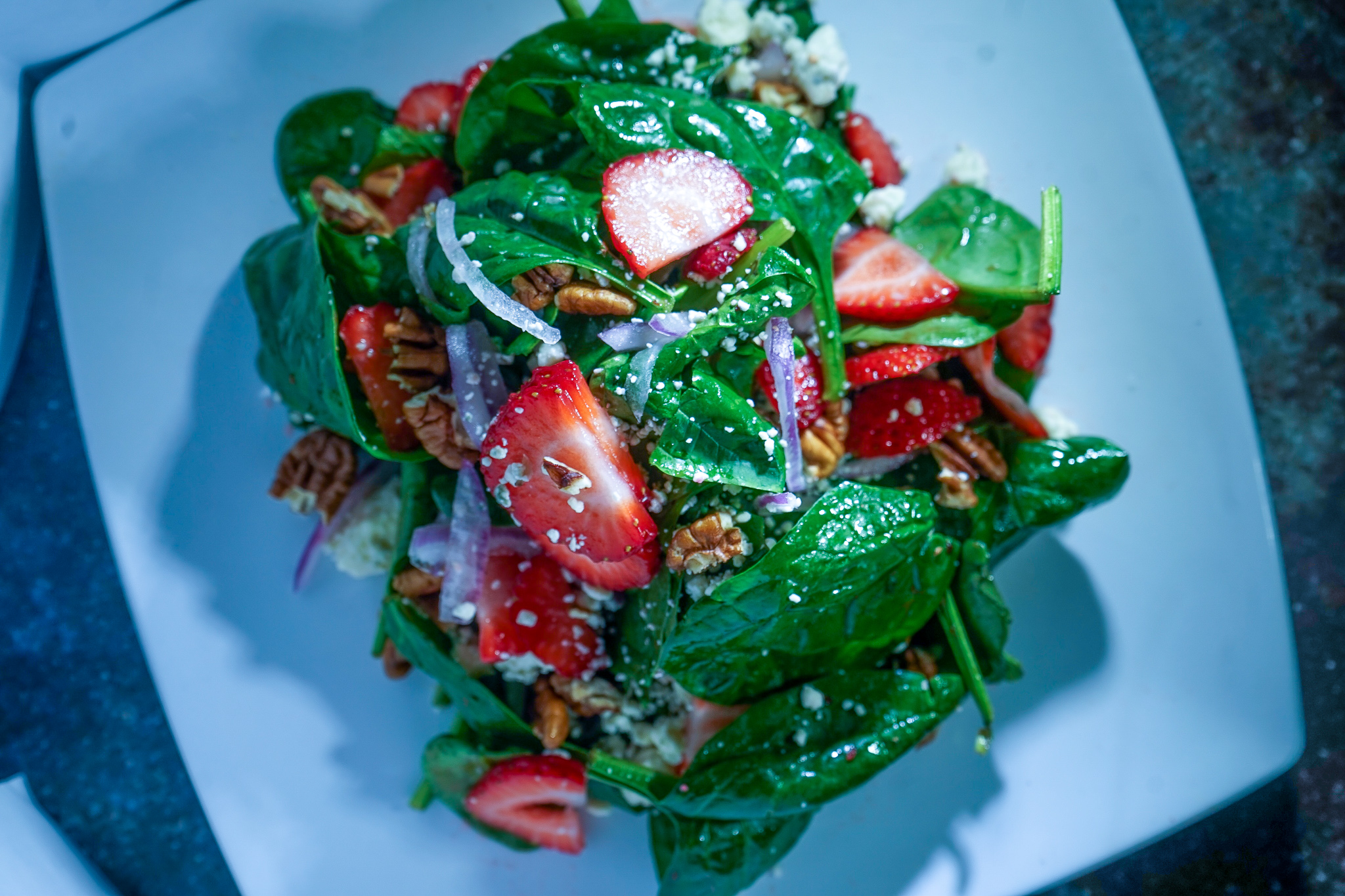 Spinach Strawberry Salad. candied pecans. red onions. strawberries. blue cheese. raspberry vinaigrette.