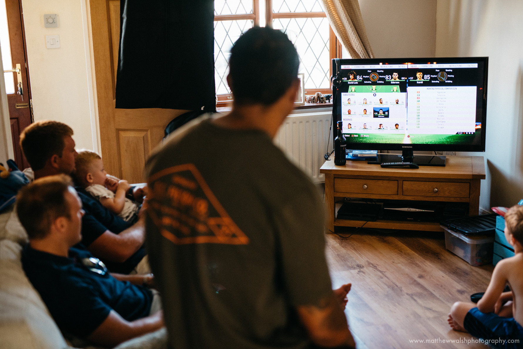 The groomsmen preparing by playing a video game