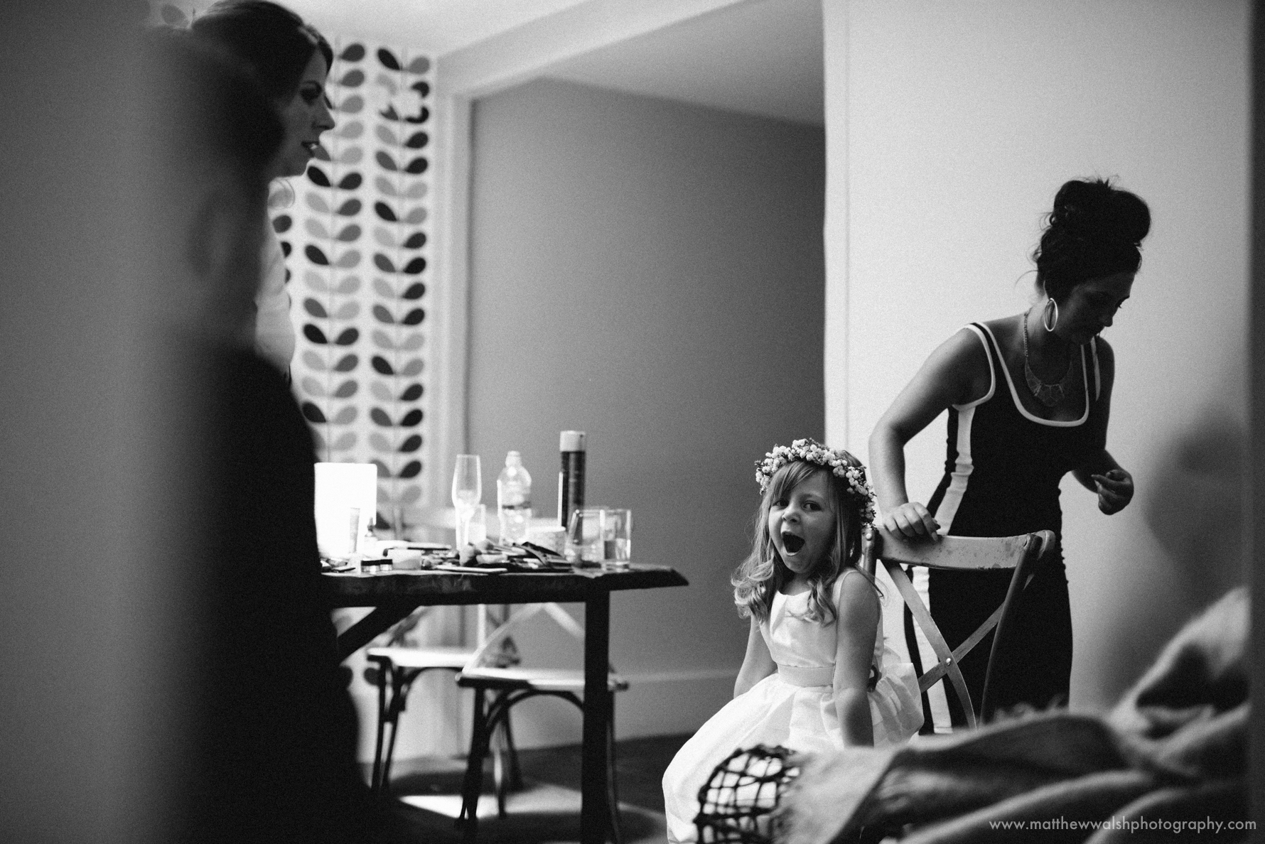 The flower girl having he hair done but getting a little tired of all the wedding day fuss