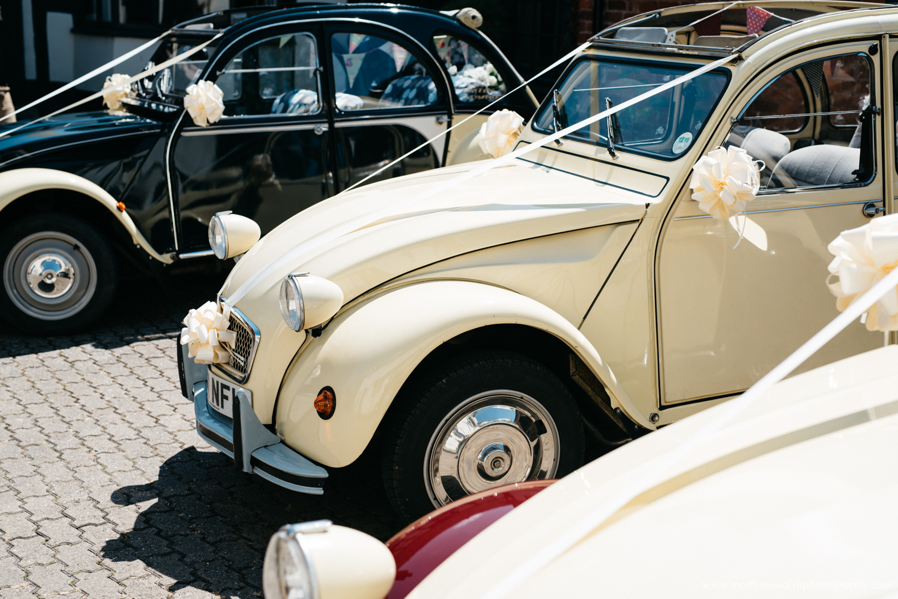 2cv Wedding cars ready to take the bridal party to the church