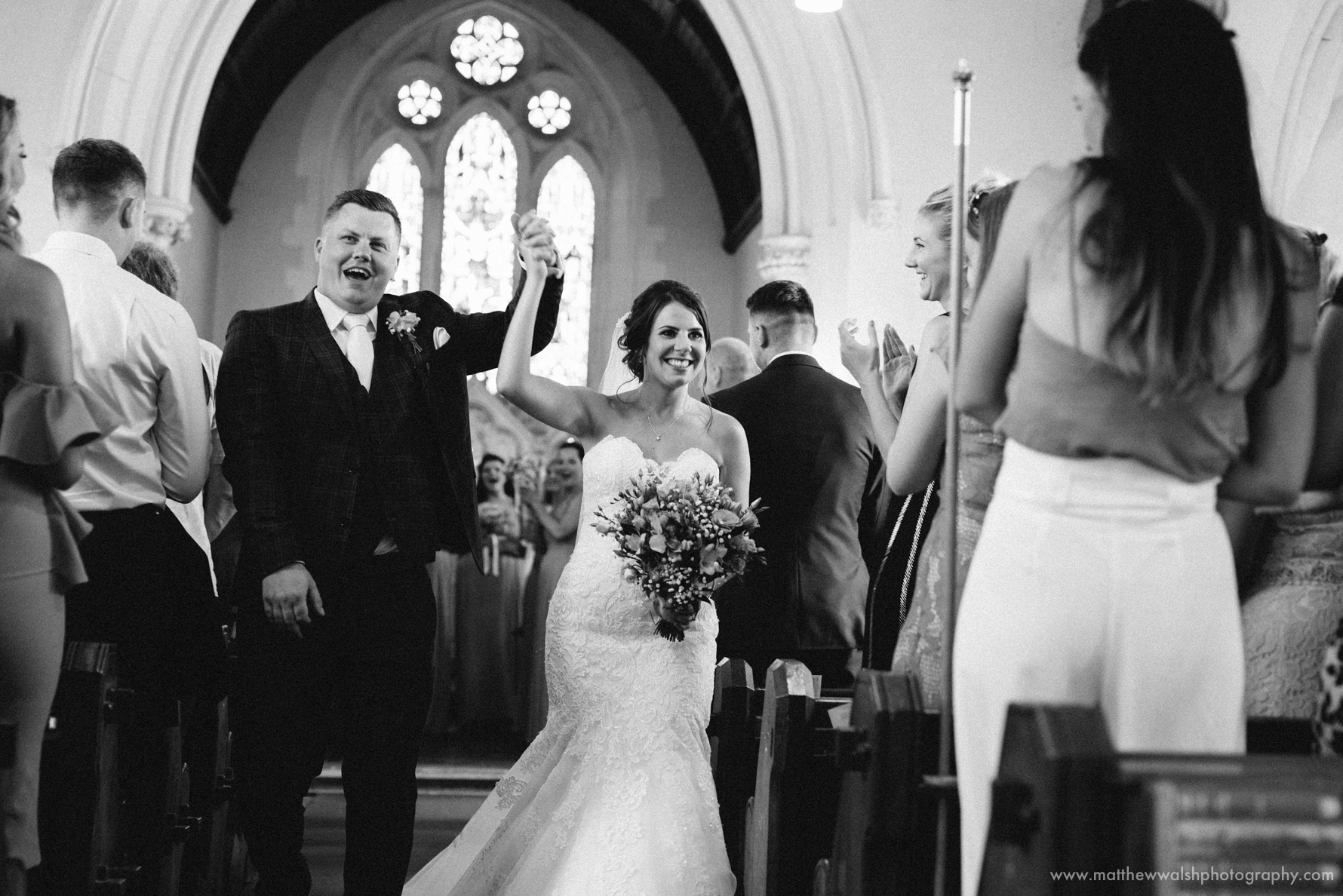 Bride and groom celebrate as the walk down the isle