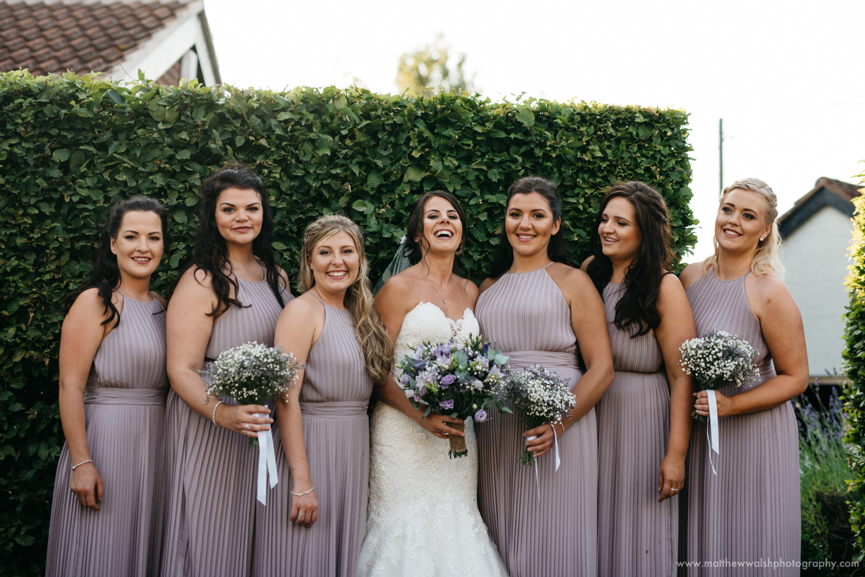 Bridesmaids post for a photograph