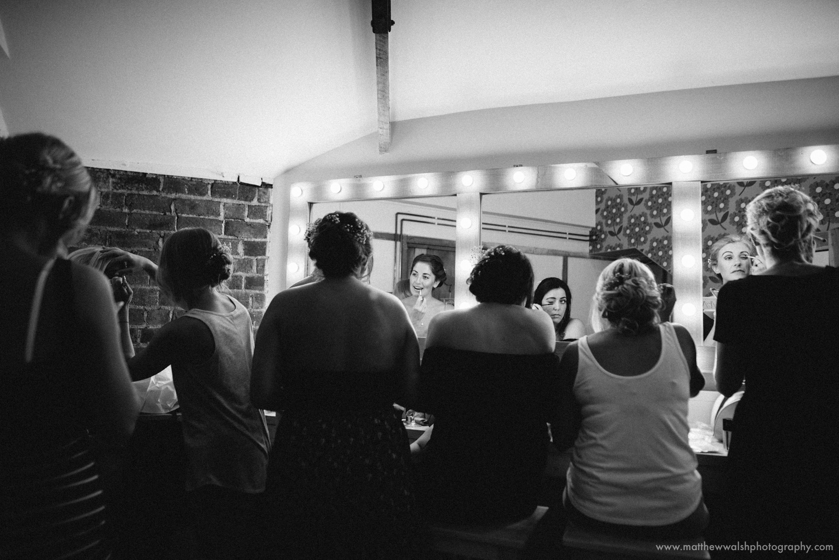 Bridal party putting their makeup on in the girls make up room