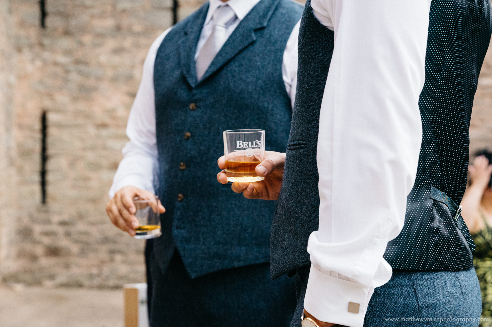 The groom calming his nerves a little more with a glass of whisky