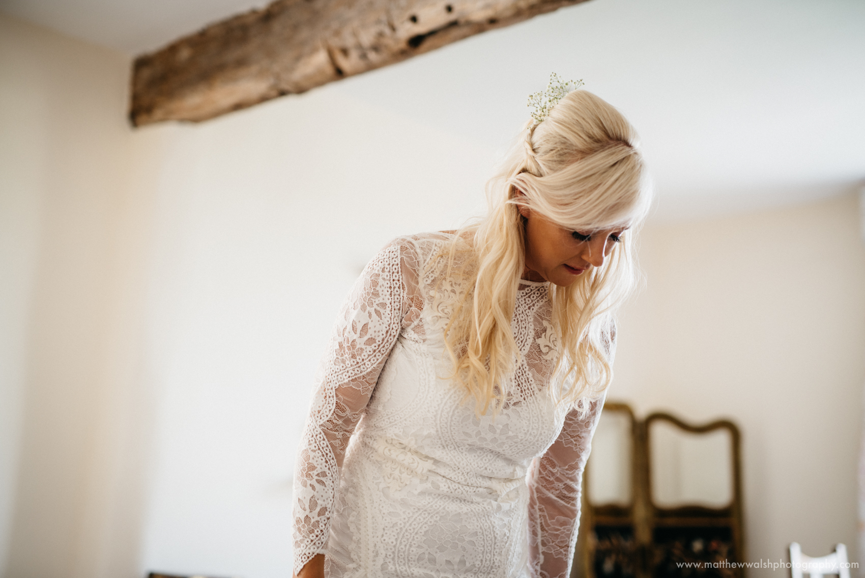 The bride looking elegant in her beautiful lace wedding dress