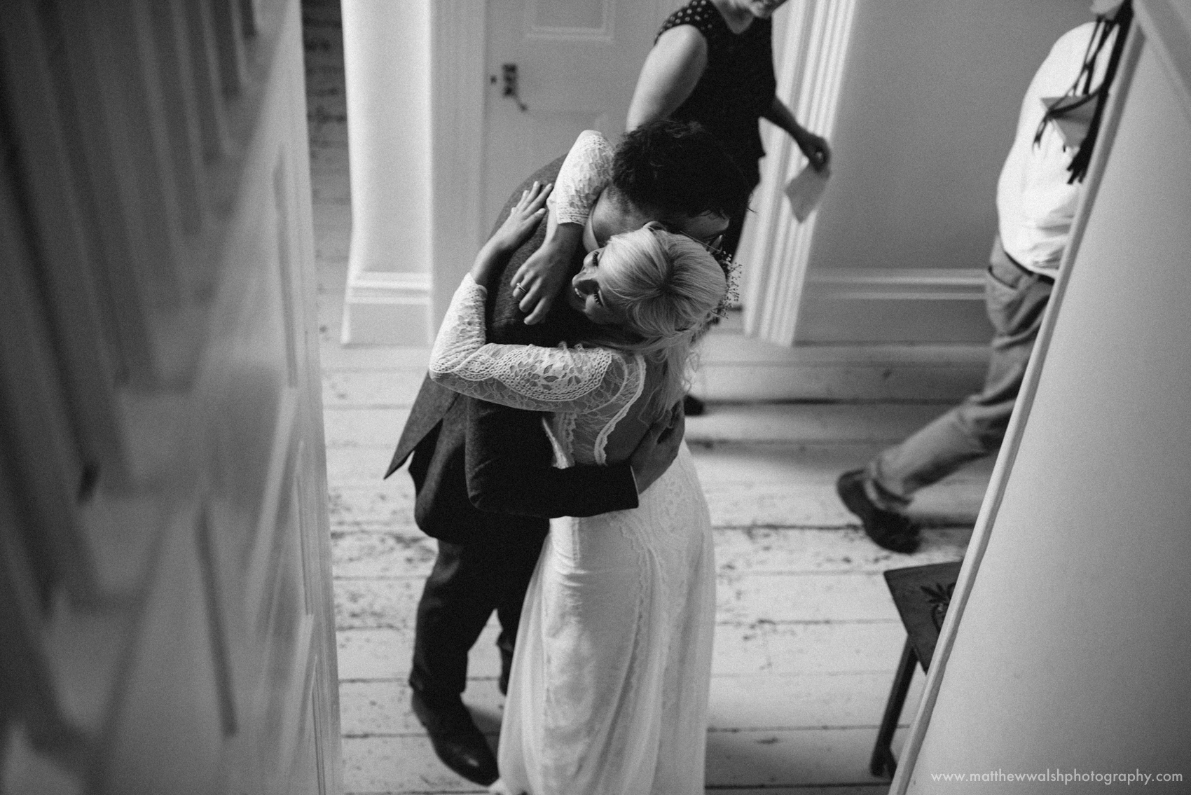 A warm embrace for the bride as her proud brother gives her a loving hug