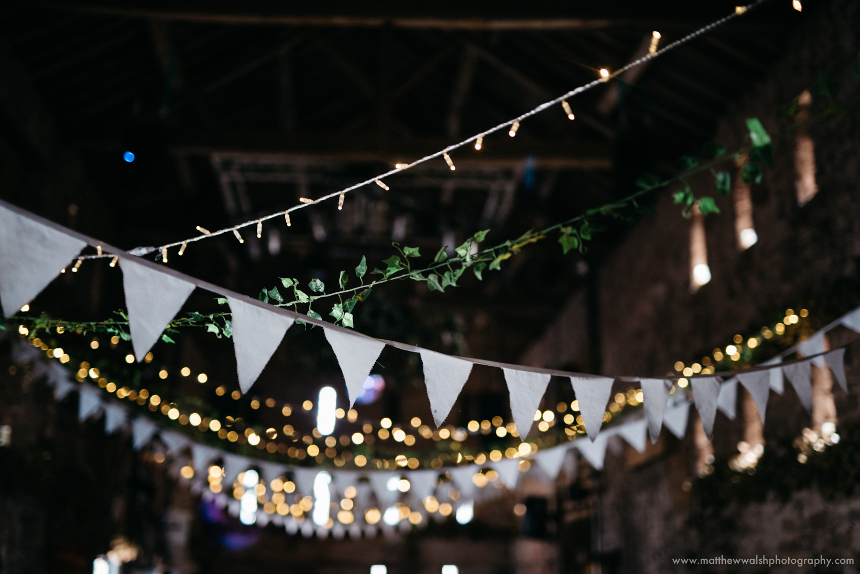 Fairy lights and bunting in the larger barn at the wedding venue