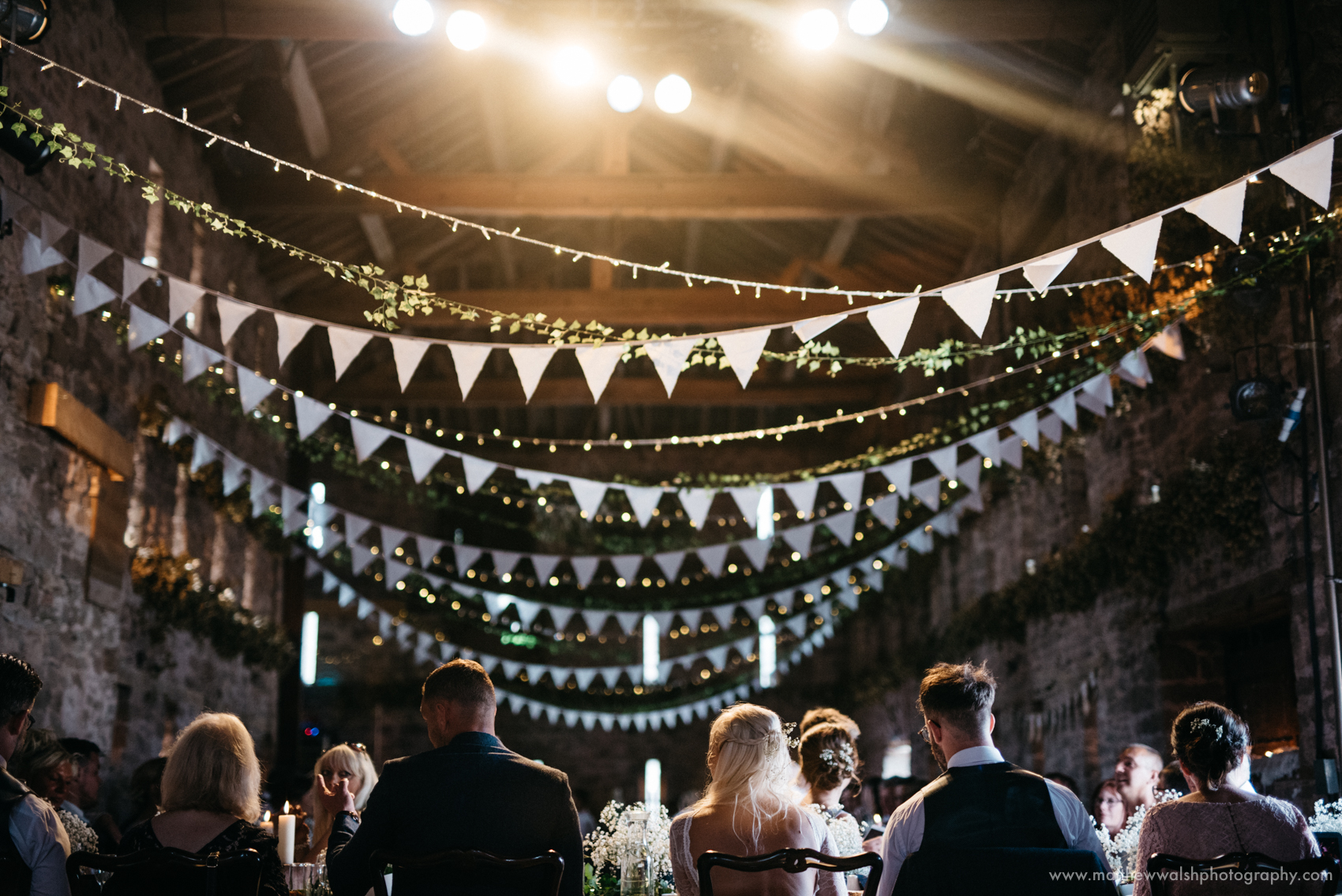 All seated in the main barn, lit by the fairy lights and spot lighting above