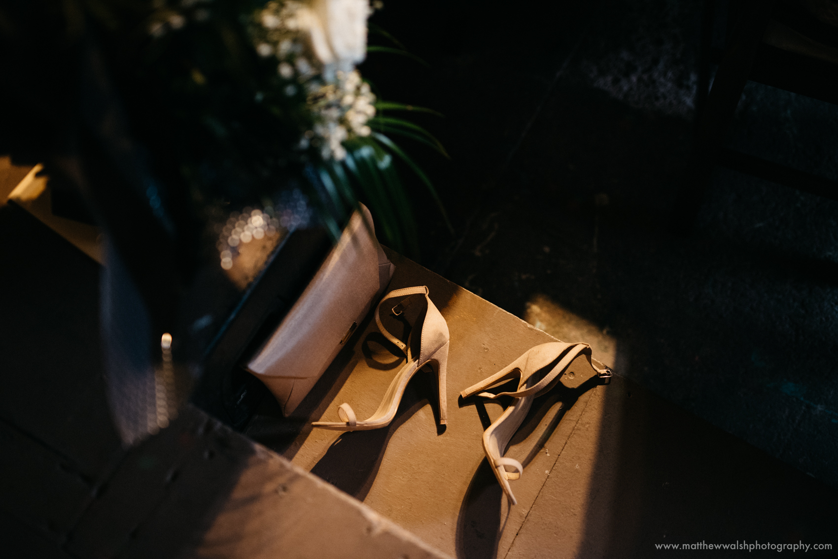 A detail of the brides shoes left on a step