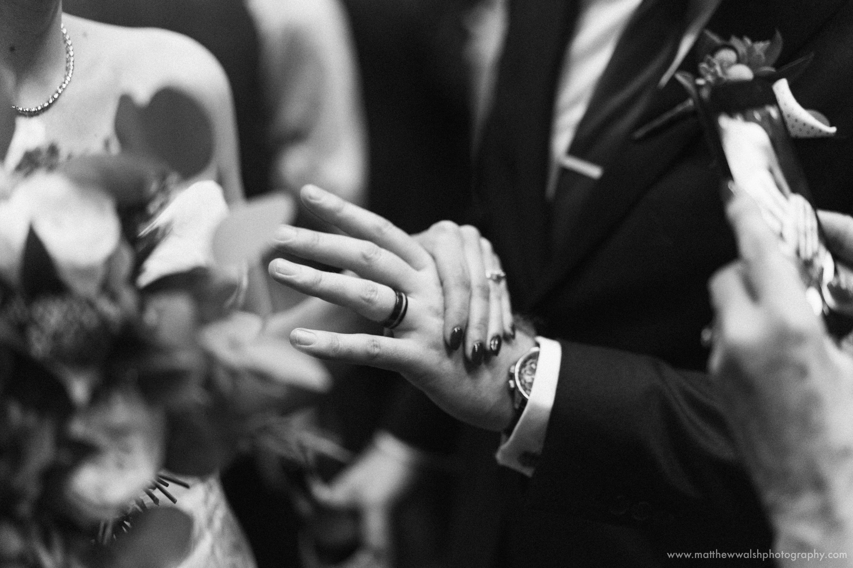 The newly wed couple show off their wedding rings to an emotional yet happy guest