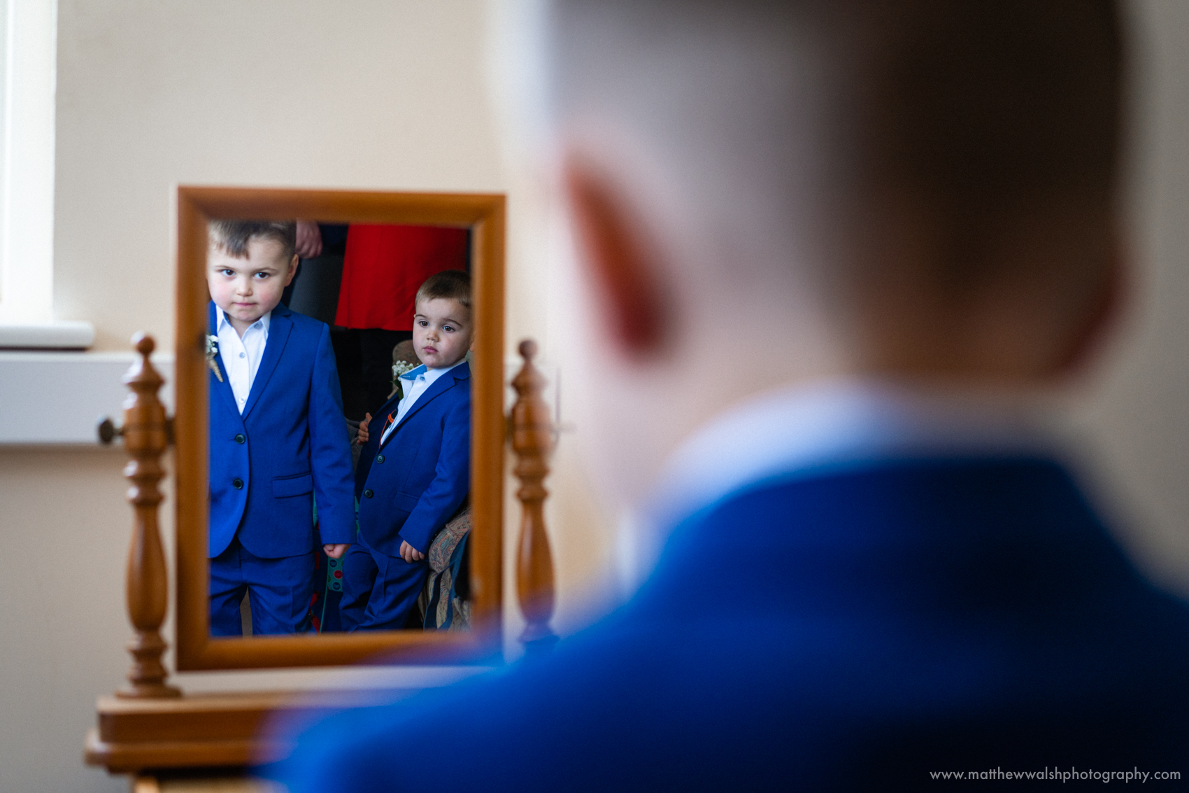 I love this image, depth created by the out of focus foreground and use of reflections to show the two boys together