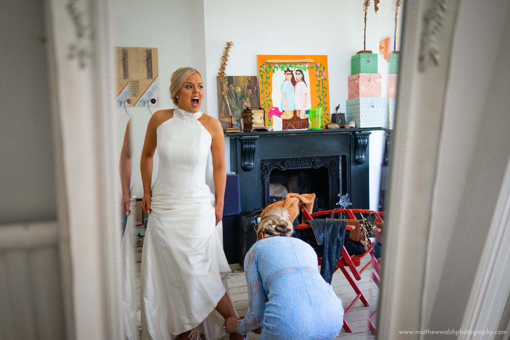 A real documentary style moment as the bride shoes are tightened too tight