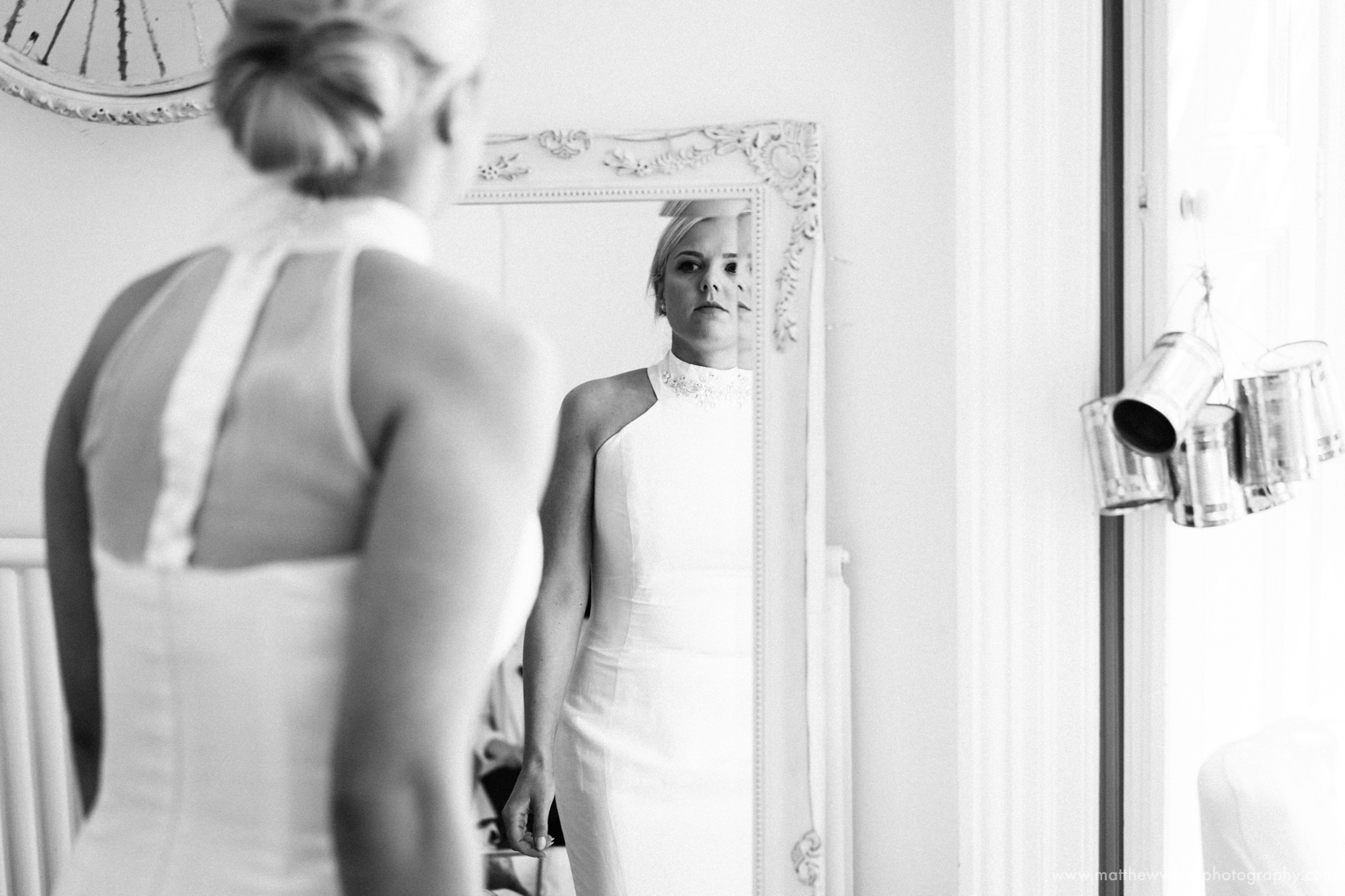 Bride almost ready checking herself in the mirror