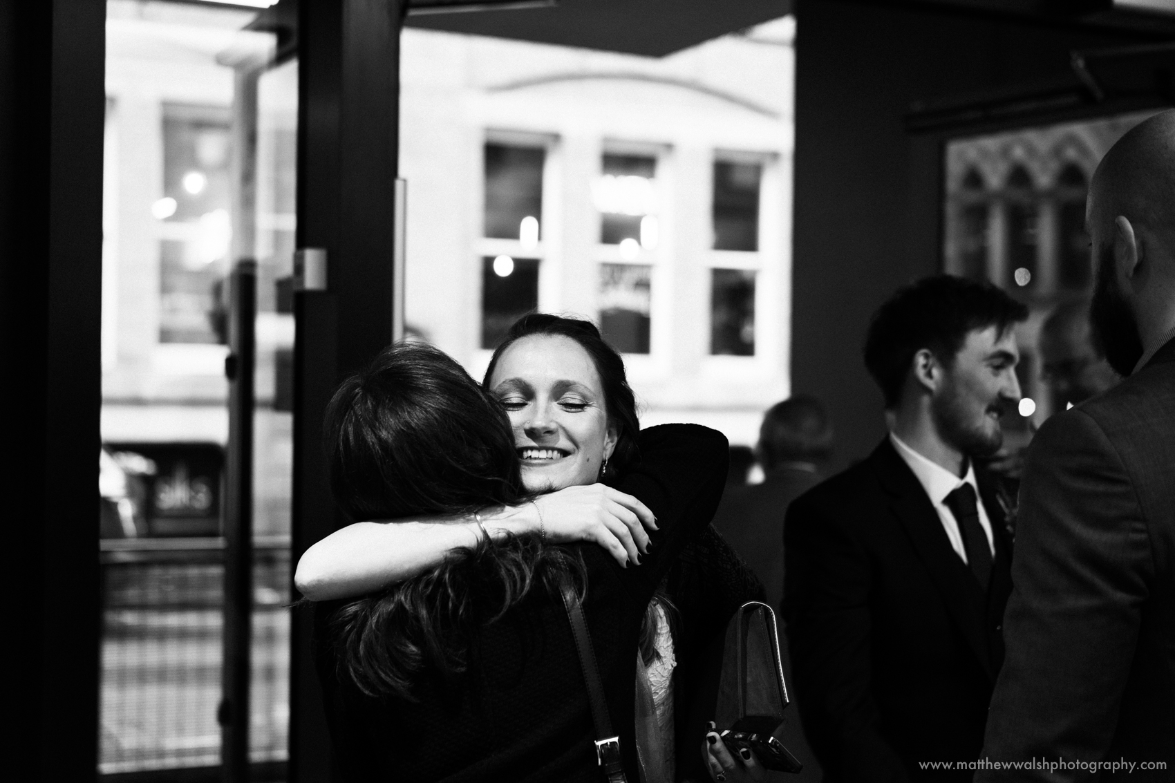 The bride hugs her oldest and best friend
