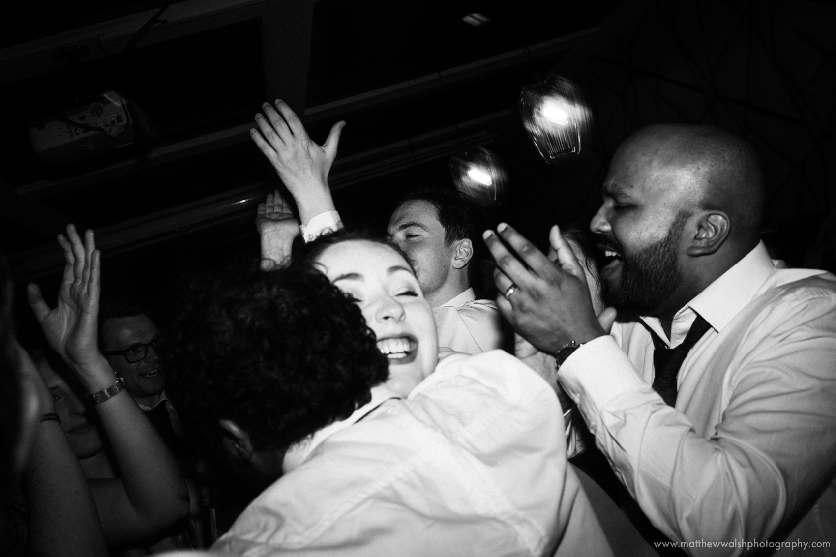 Guests dancing and hugging at an alternative wedding reception at the Living room in Central Manchester