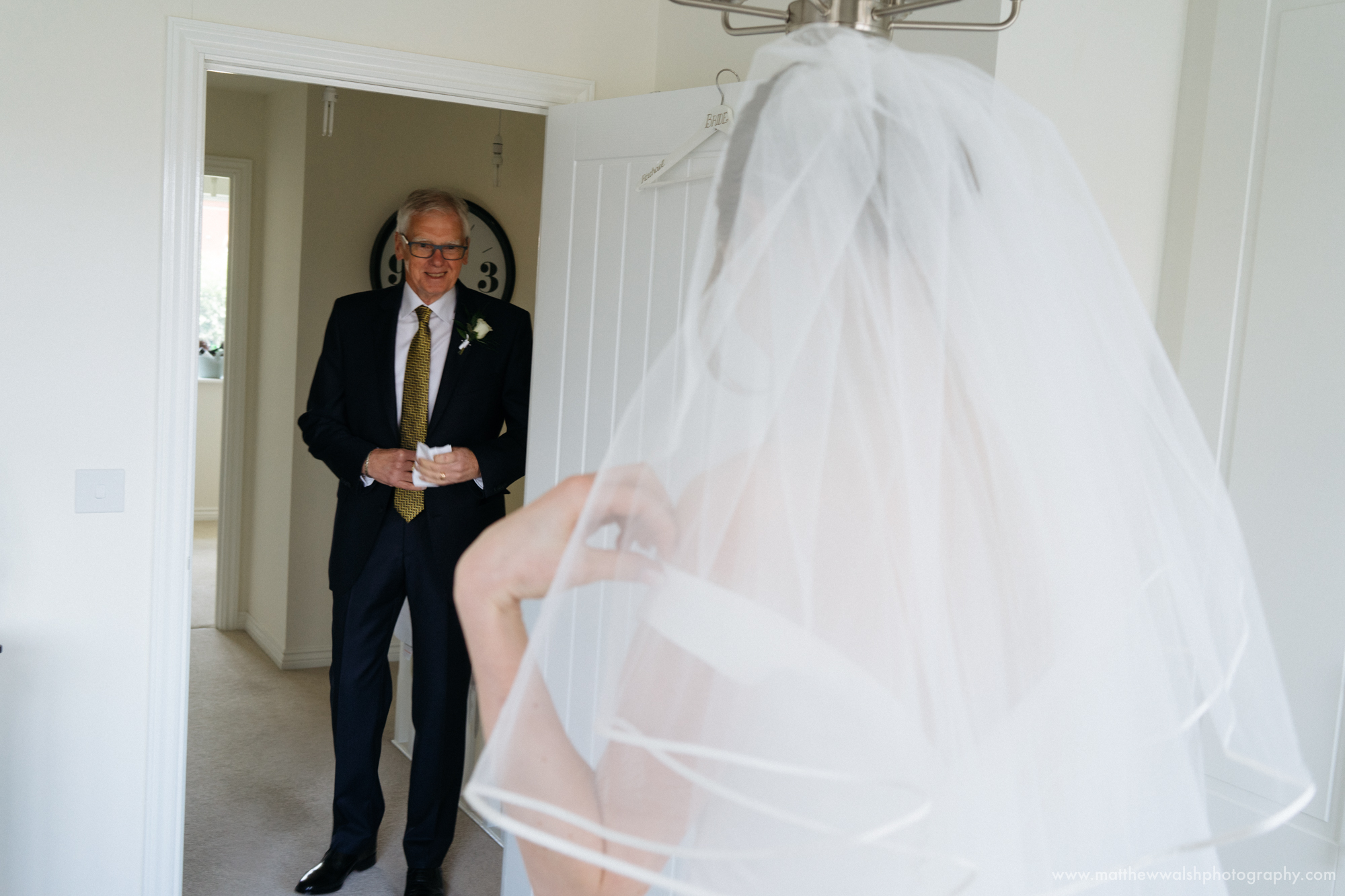 The first look as the father of the bride sees his daughter in her wedding dress for the first time