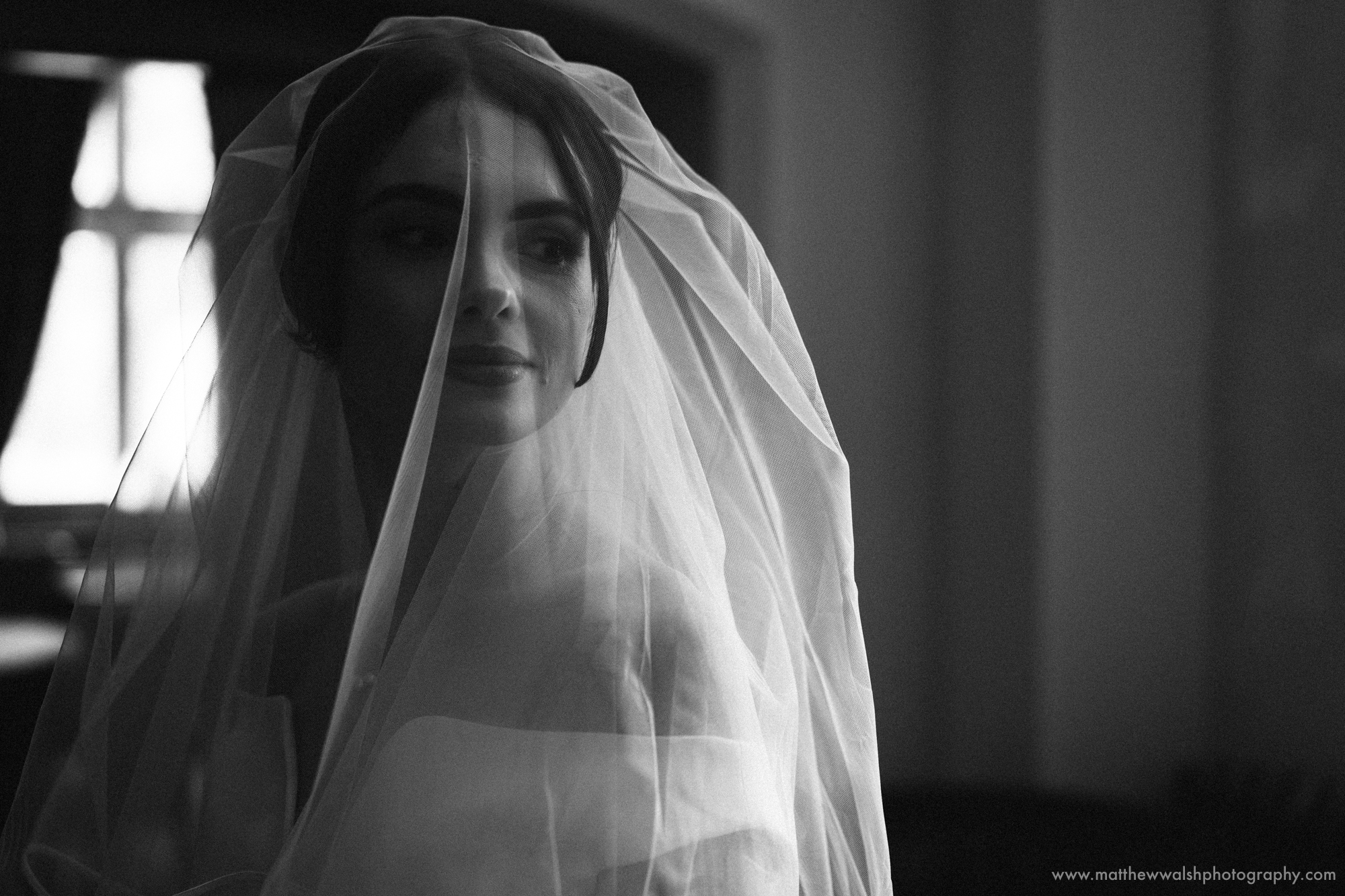 The bride in her veil about to walk down the isle
