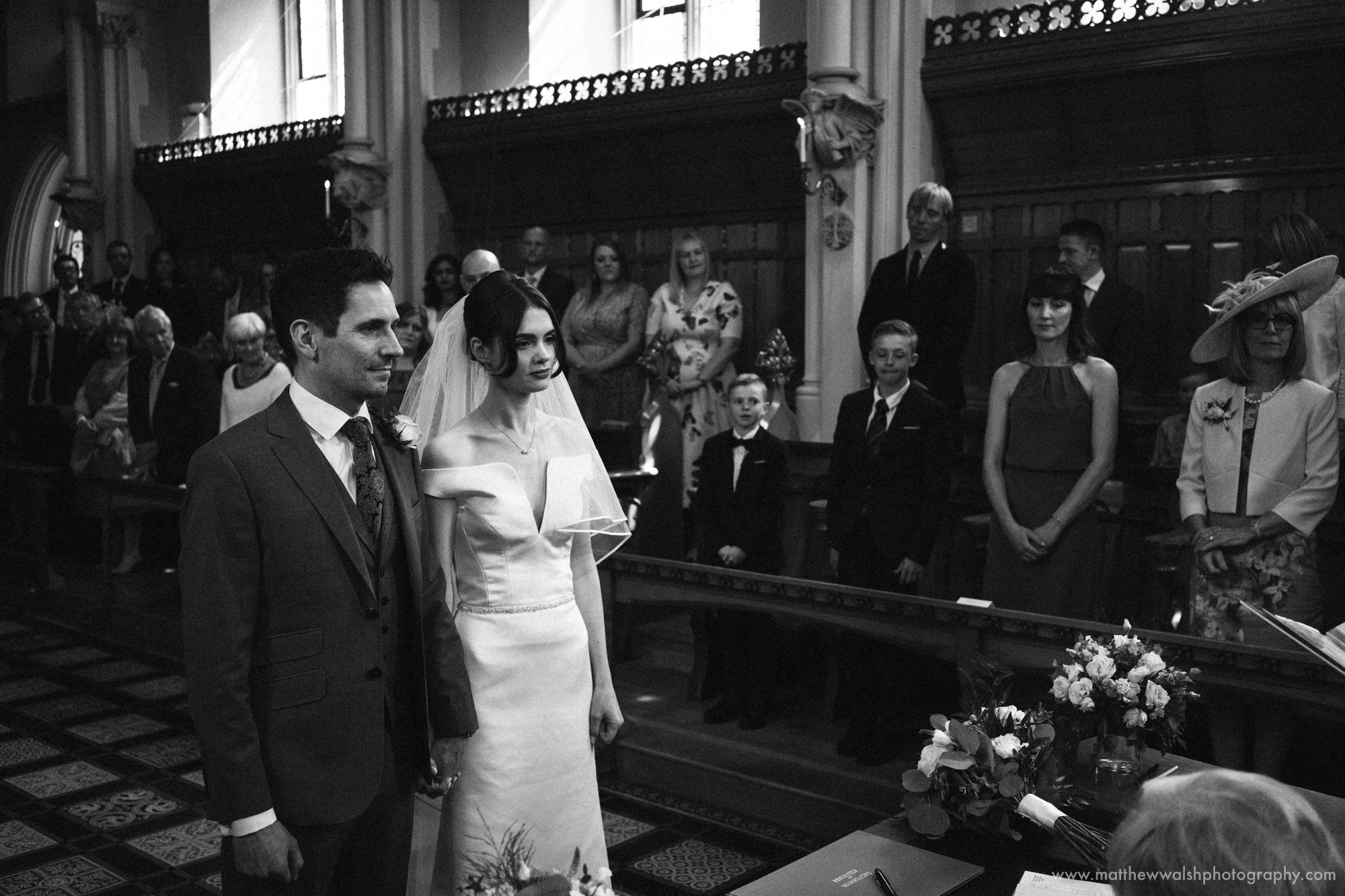 an emotional black and white image of the happy couple during the ceremony