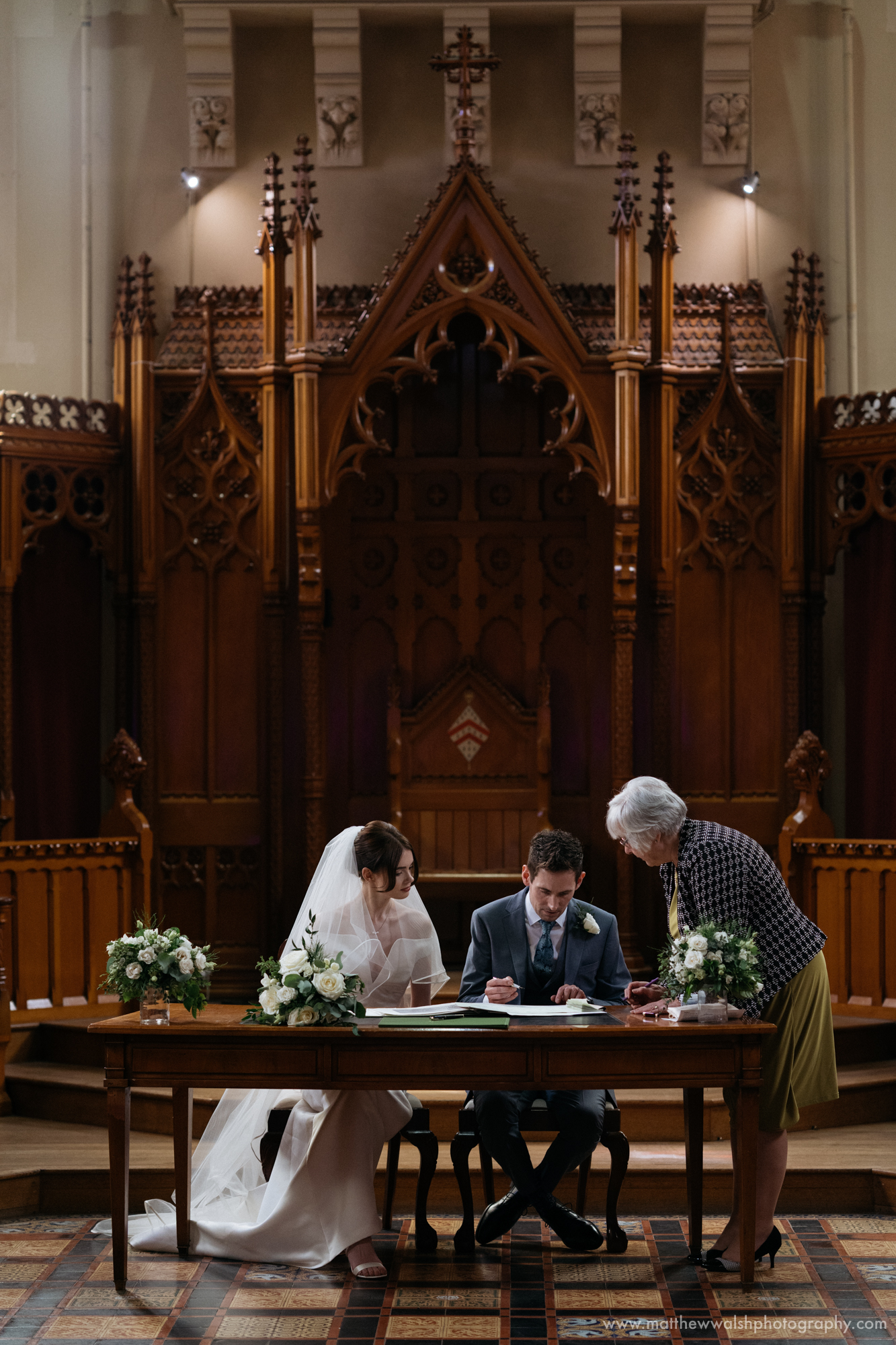 Signing the wedding register in the hall chapel at Stanbrook Abbey