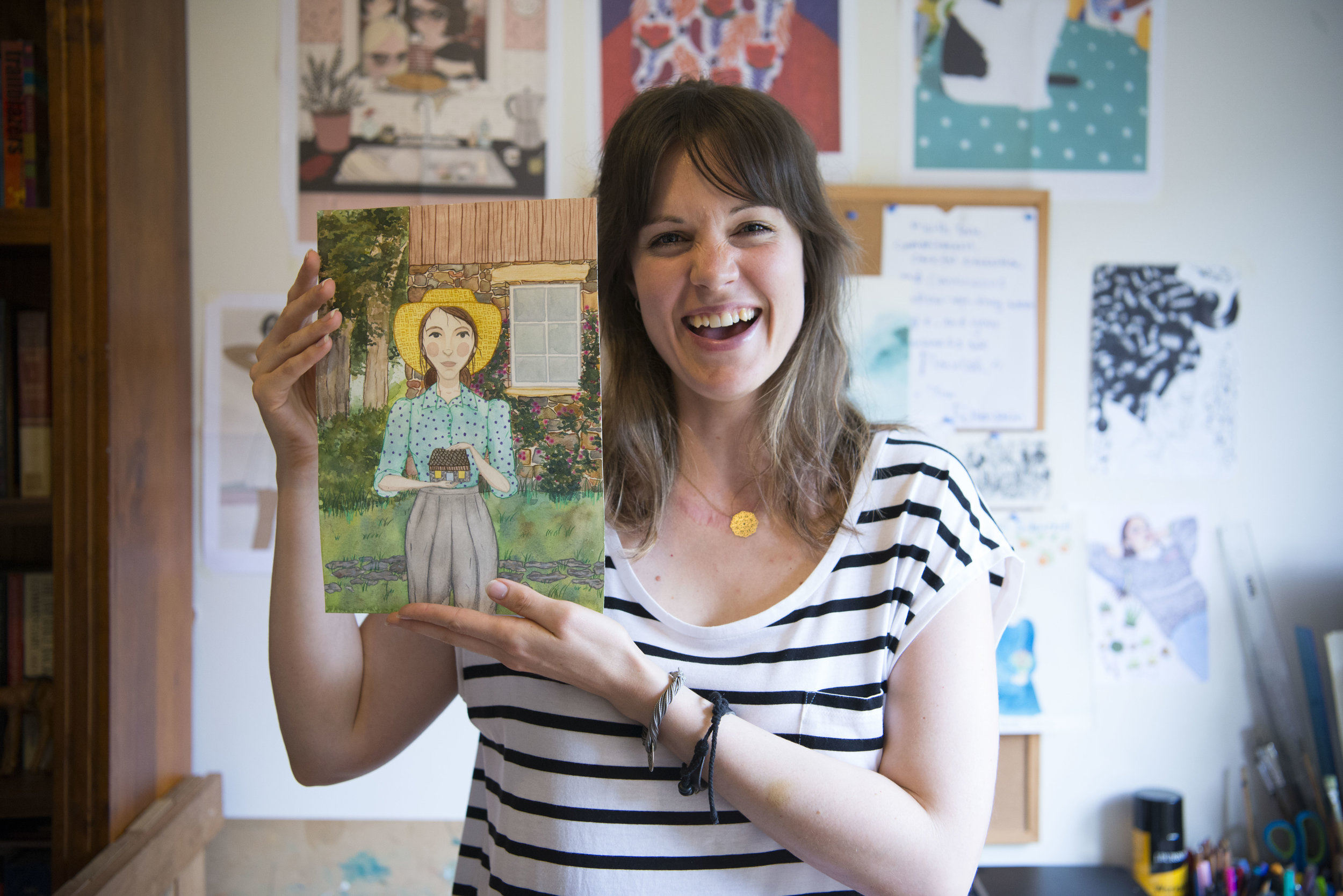 Artist Edwina Marion with one of her eight original artworks. This art accompanied a story about Lexie Goyder, a self-taught architect and builder who called Warrandyte home.