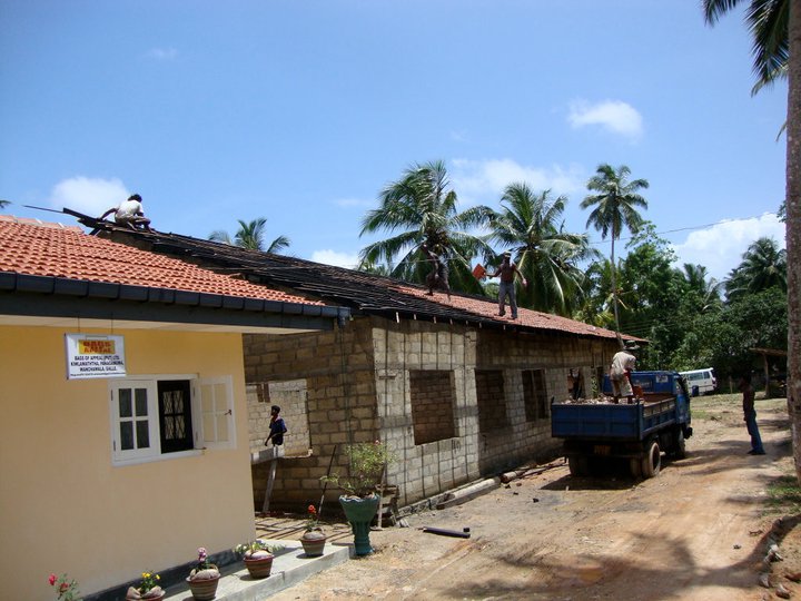 School roof today lunchtime! this side next door is our Workshop! Raja is in the truck heaving the tiles up in the air to the guy on the roof he then throws to the next man who puts them in place! Bingo