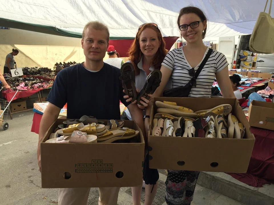 Daniela with her husband Malte and volunteer Leah buying shoes in the Saturday Bazzar