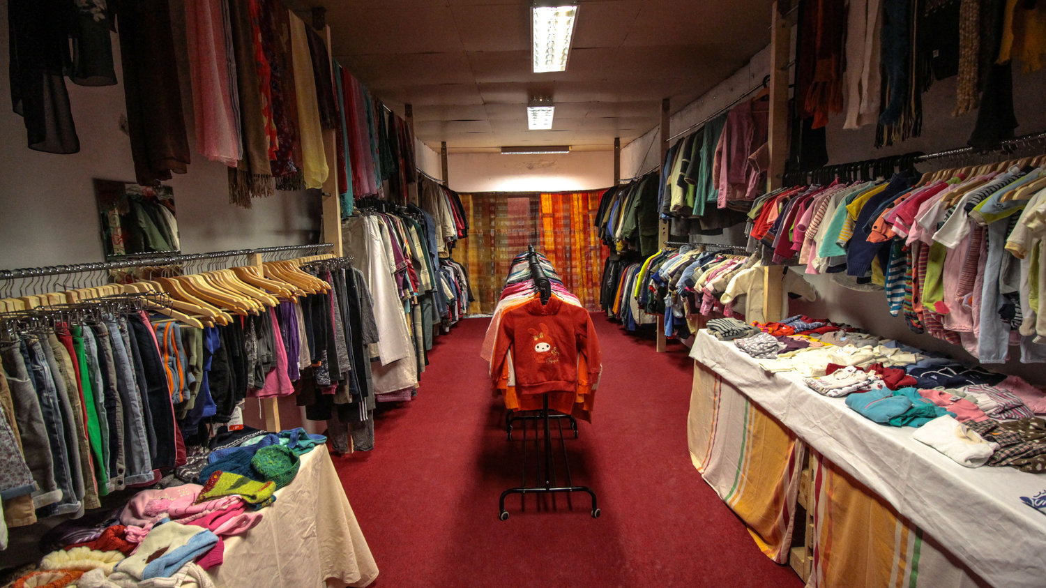 The Clothes Shop stocked and ready for residents to try out, this is how it looked after the guys from Refugees Foundation, e.V. Support for Refugees on the Ru n came and fitted a ceiling with storage ontop
