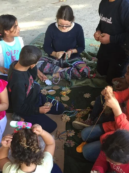 Leah making bracelets with the kids