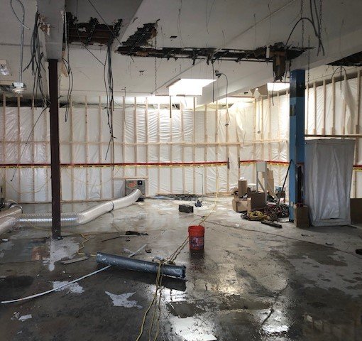 interior of asbestos abatement work area with negative air units.JPG