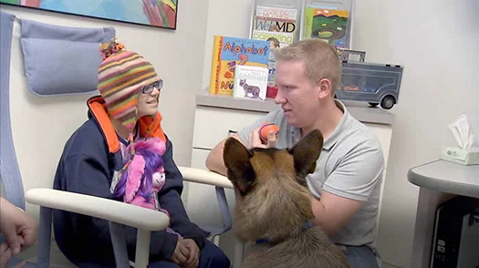 Ralph and Kaitlyn bond in Advocate's Hematology and Oncology Department. (photo courtesy of Reporting for Service)