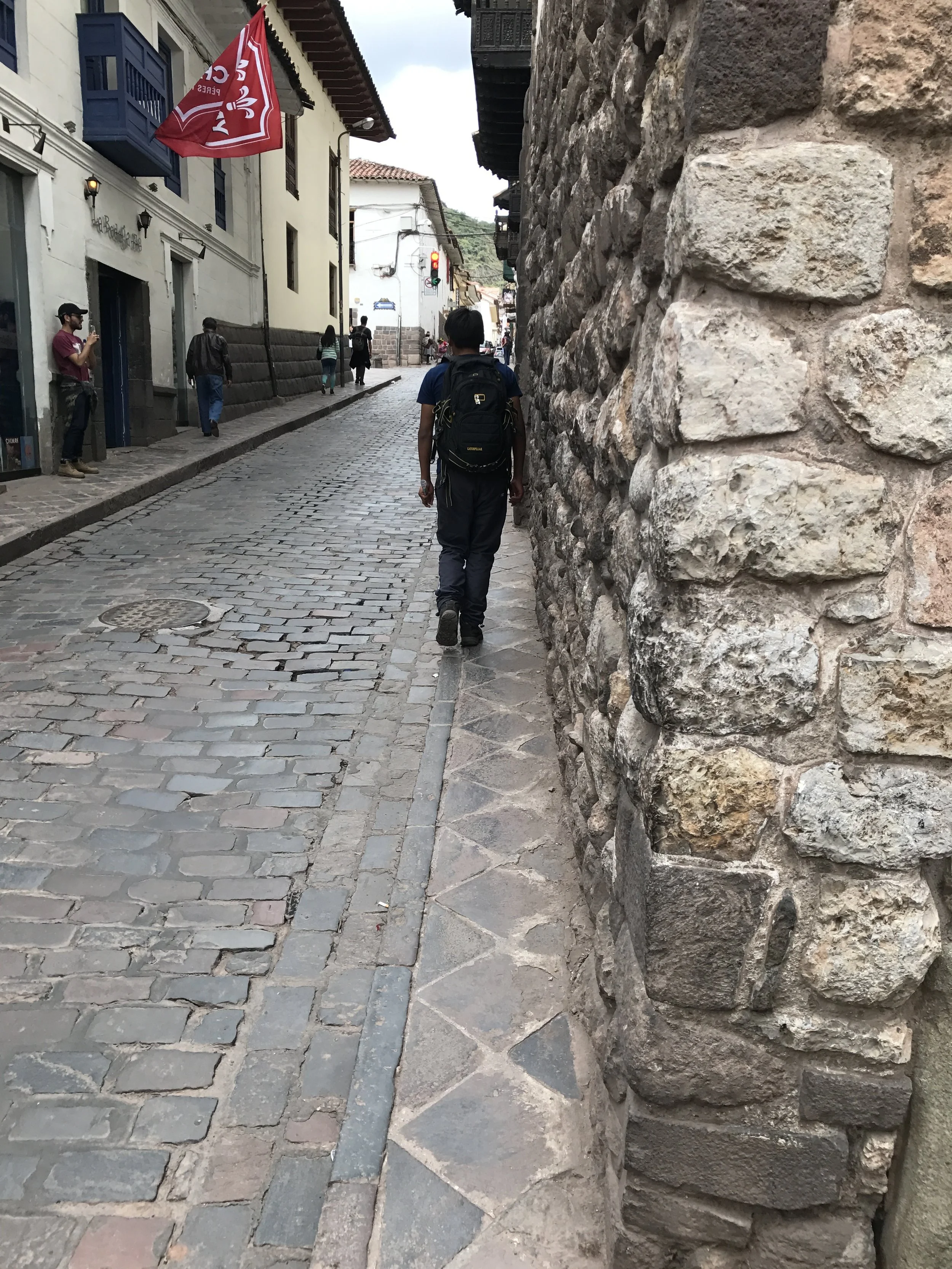 Narrow streets and sidewalks in Cusco.
