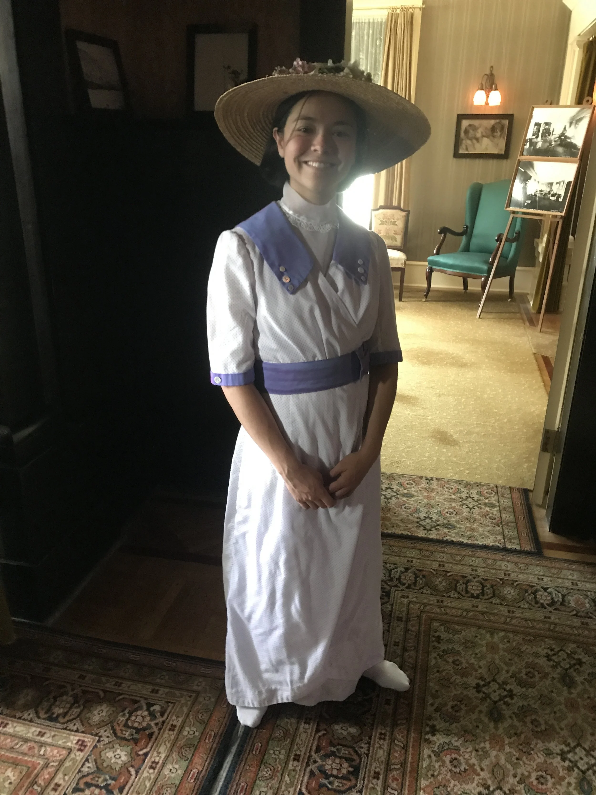 Parks Canada employee dressed like the lady of the house 100 years ago.