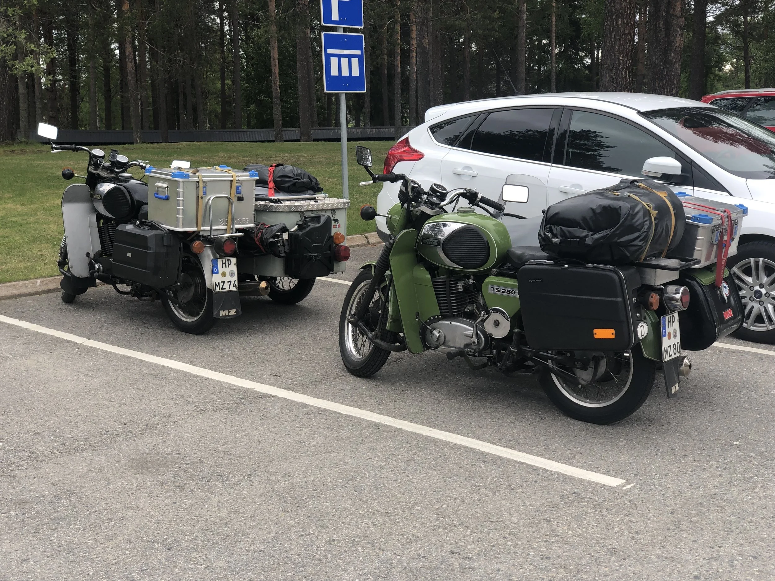 A couple of 250cc MZ Motorcycles with sidecars.