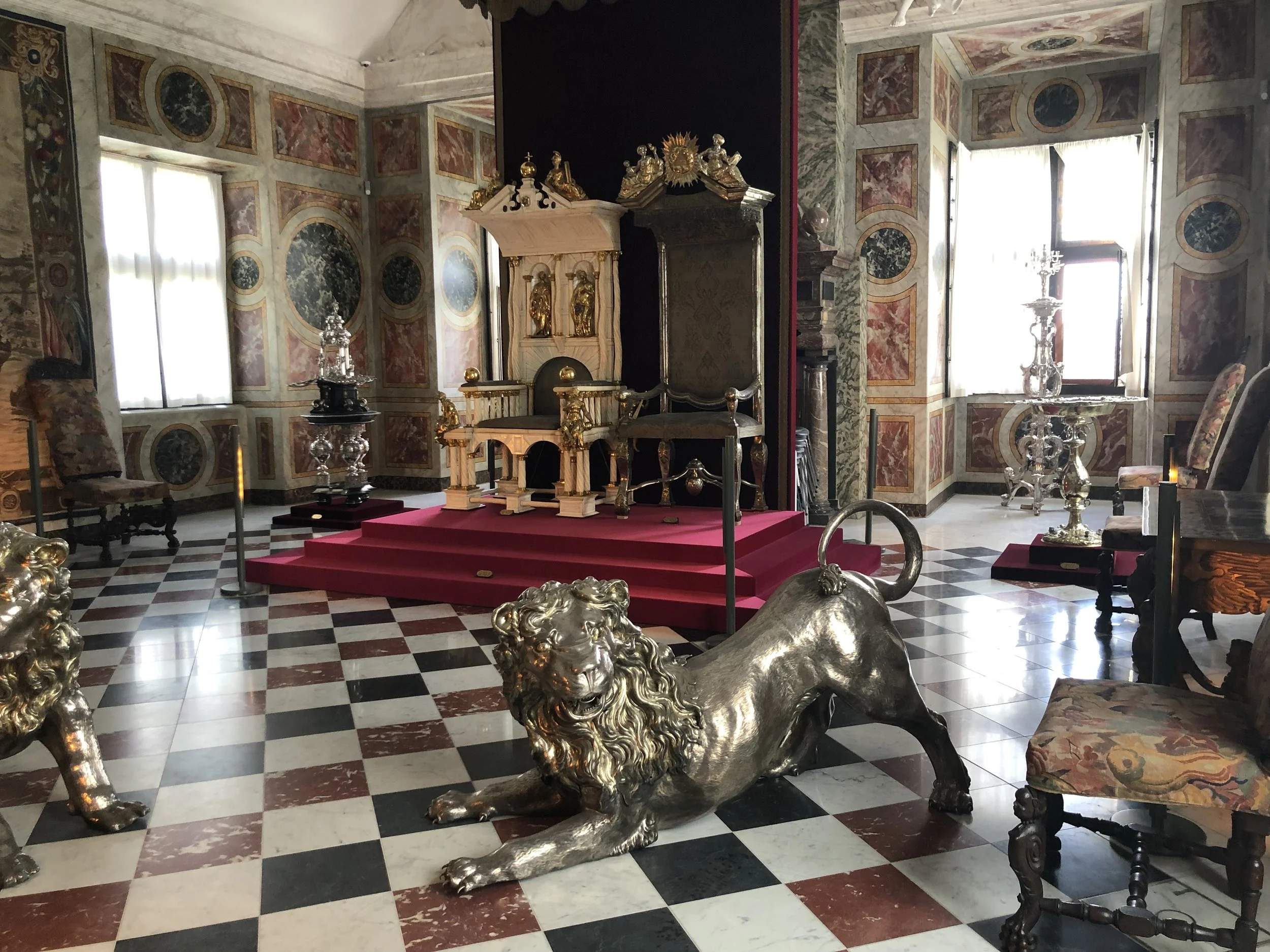 Silver lions guarding the throne.