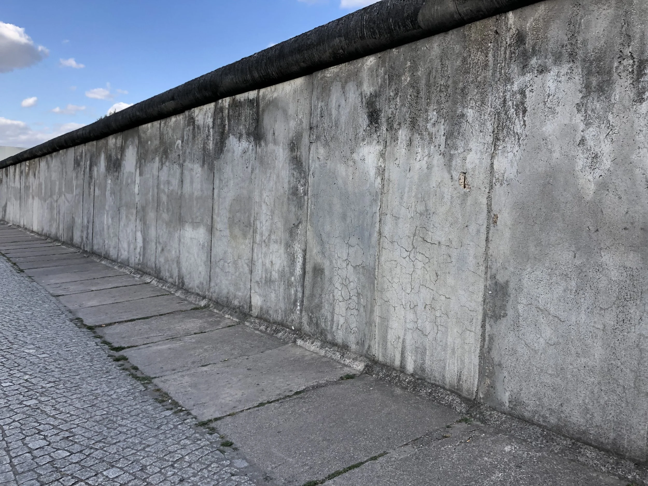From Hamburg we took the train to Berlin. Shortly after our arrival, we headed to a nearby memorial to the Berlin Wall. Throughout the city there are memorials where the wall once stood. At this one they kept a section exactly the way it was back in the 60’s. The wall was ten feet high with guard towers located periodically along its route. On the East German side of the wall all buildings within a couple hundred feet of the wall were taken down to prevent escape attempts.