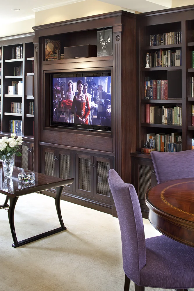 The books have rotated to reveal the concealed television.
