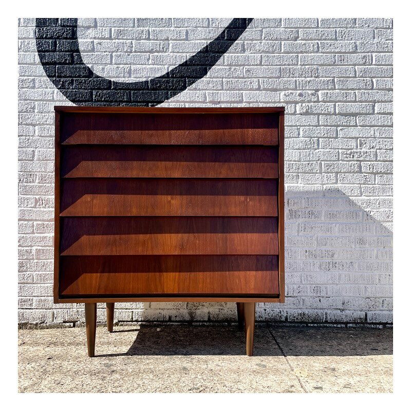 1960s walnut dresser with five drawers sloping in at an upward angle. The gorgeous walnut grain &amp; angular facade on this chest of drawers is without interruption from top to bottom and free of hardware. This piece has been lovingly restored in it