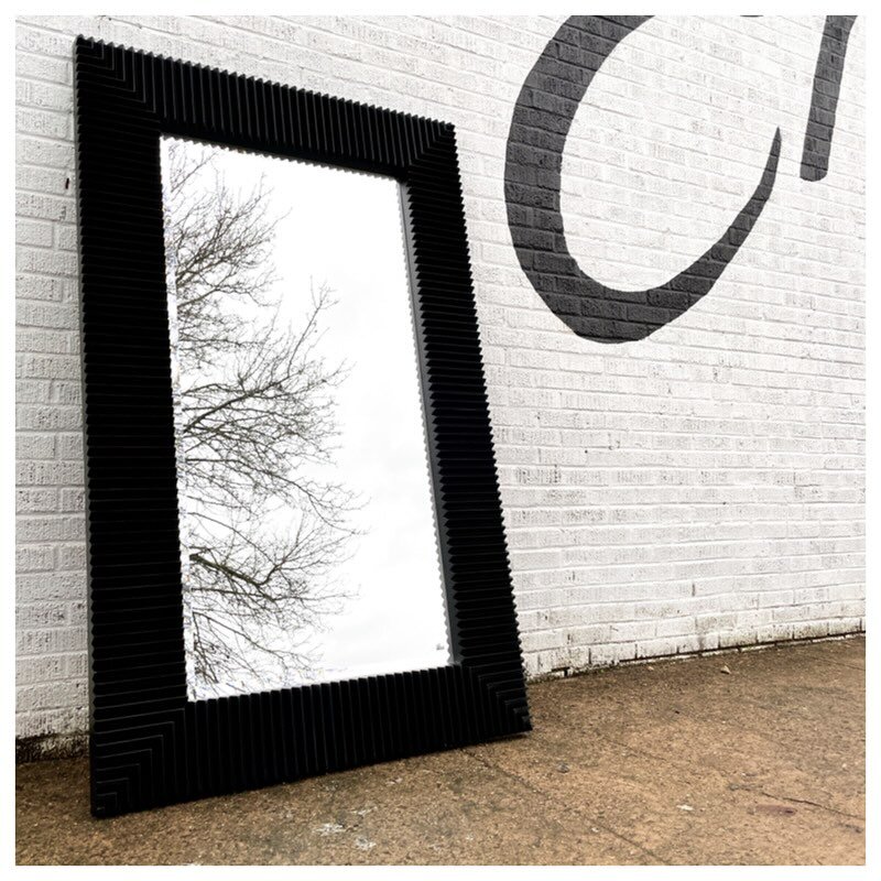 Massive postmodern floor mirror by Bassett Furniture out of VA. Frame is a wide, black wood with a wedge design. It has hardware on its back for hanging if desired. 
75.25&rdquo;x45.25&rdquo; &bull; $425
