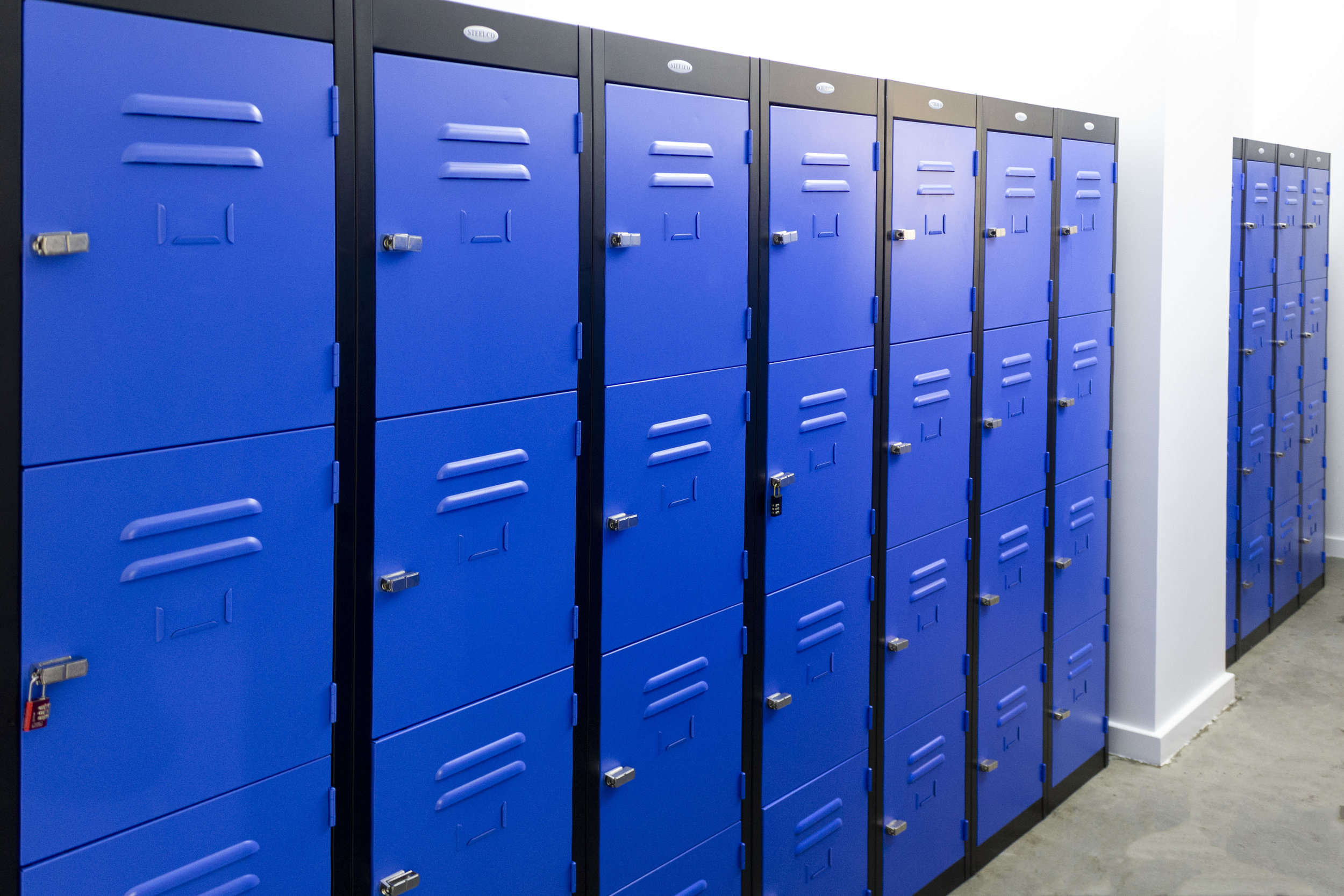 Blue Four-Door Steel Locker with a Black Matte Finished Carcass. 