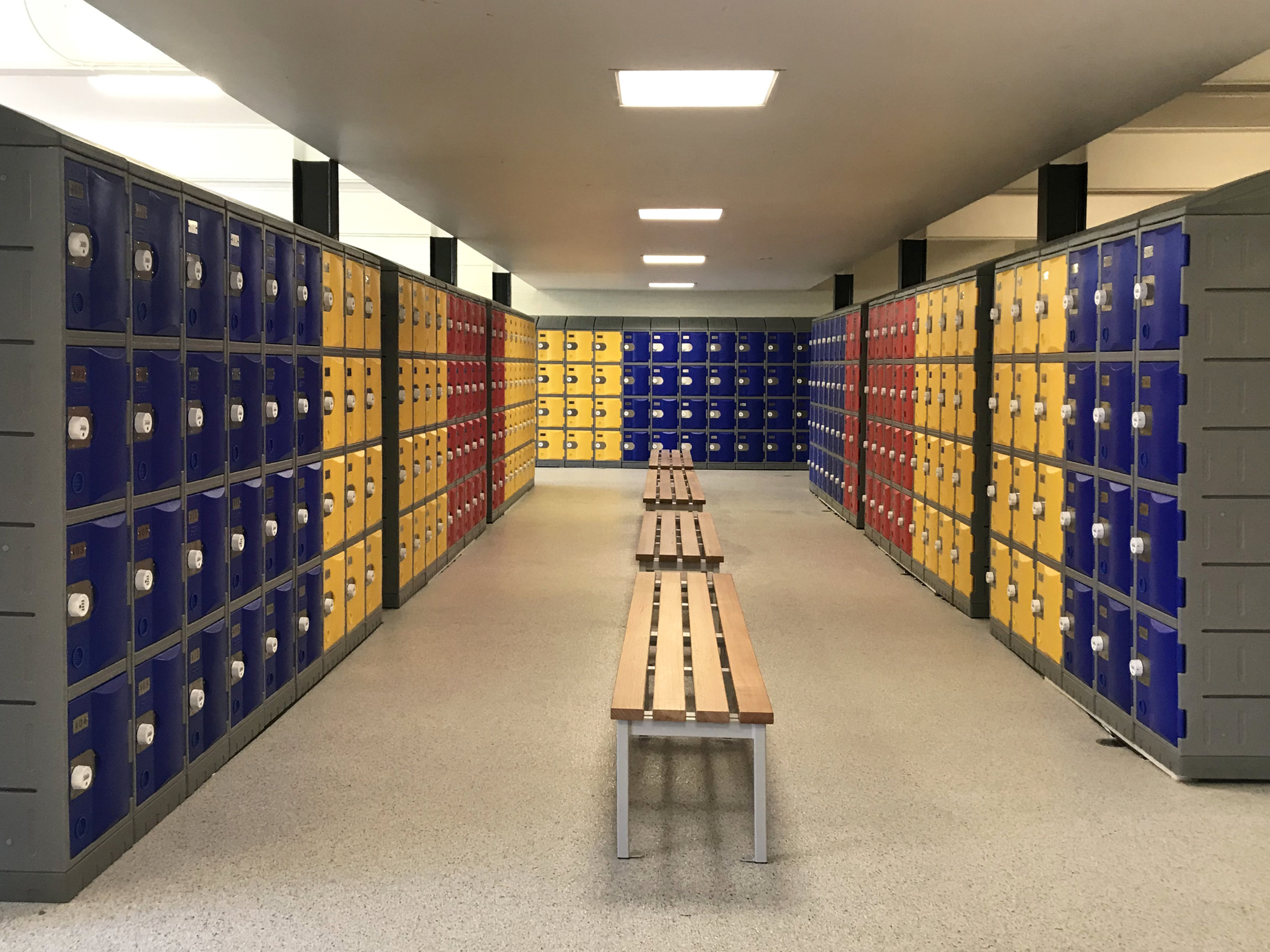 Bays of red, yellow and blue heavy duty plastic lockers.