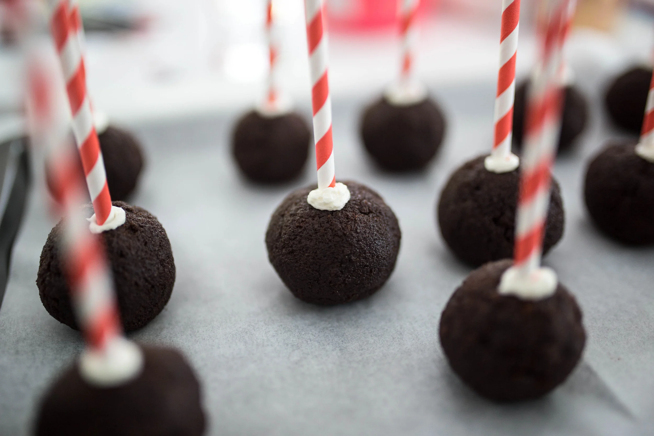 The straws were first dipped into the icing then pierced more than half way through the cake pop.