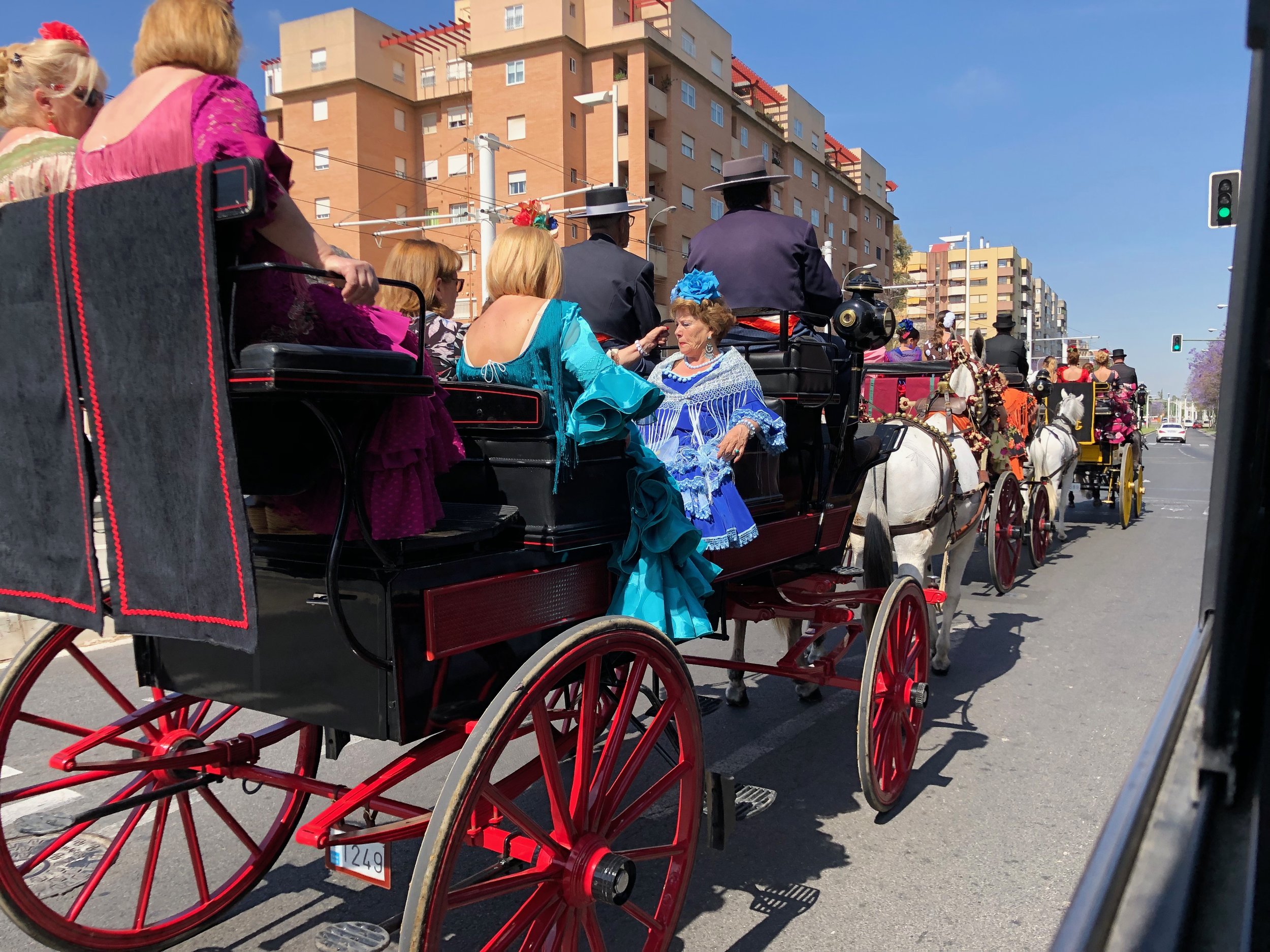 The horse-drawn carriages and their dressed up passengers mingle with cars and buses on the roads to the fair.