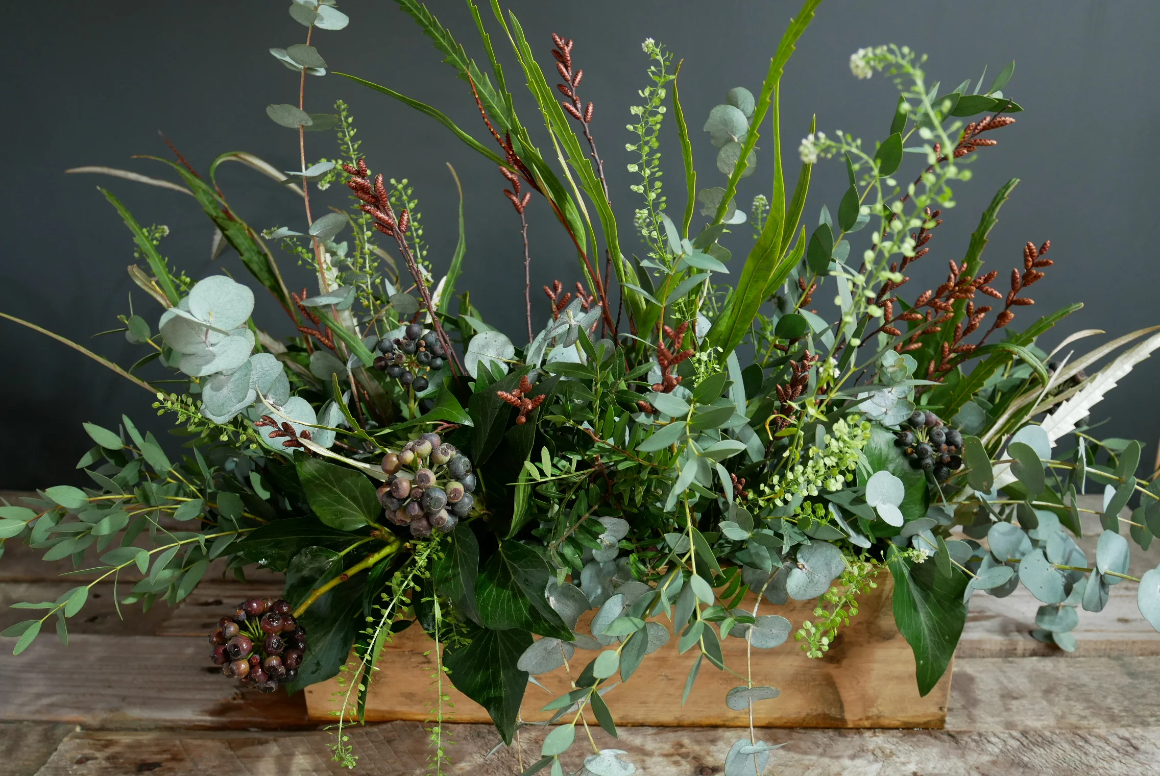 Rustic wooden crate full of foliage and berries