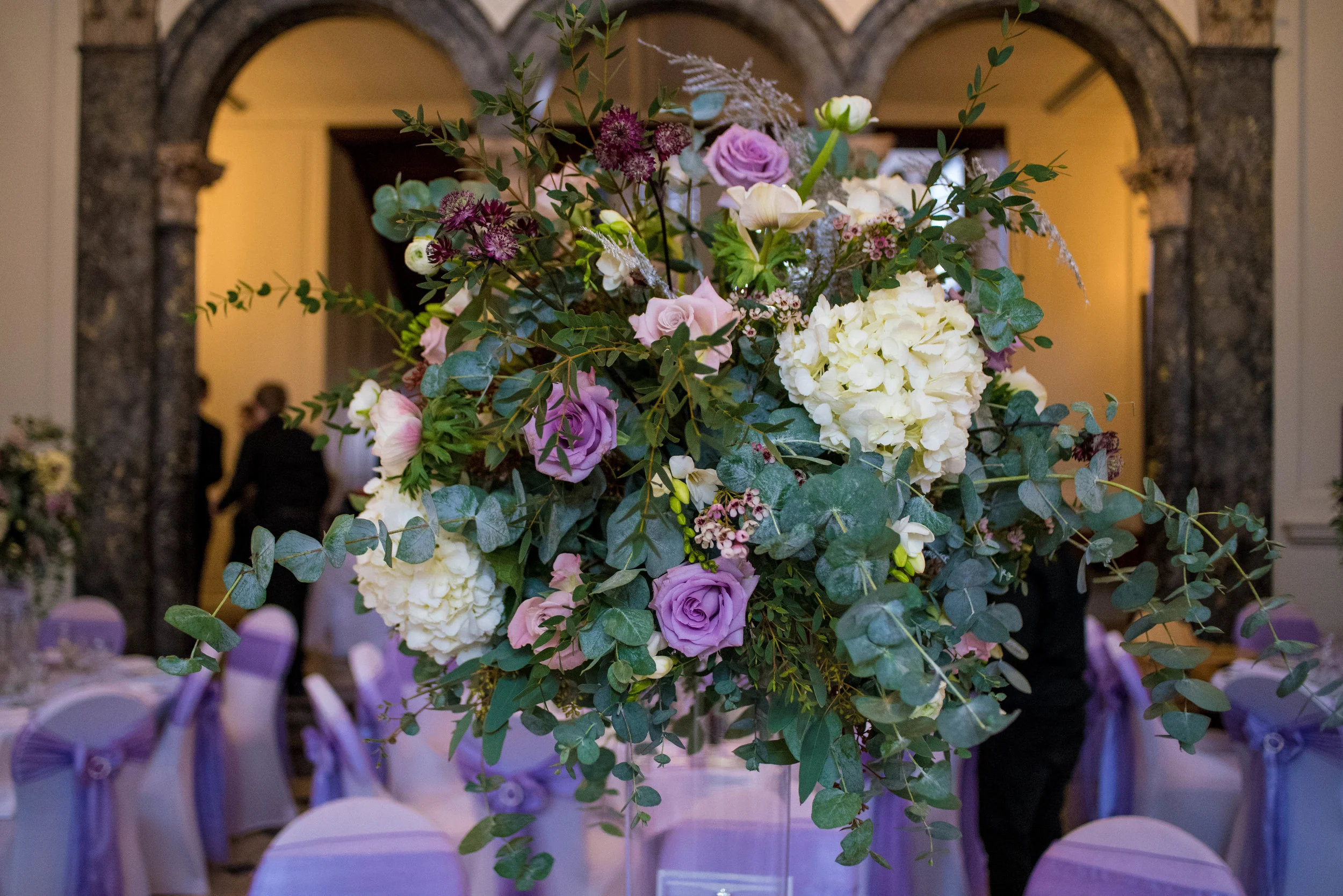 Tall centrepieces full of hydrangeas, roses, freesias and anemones