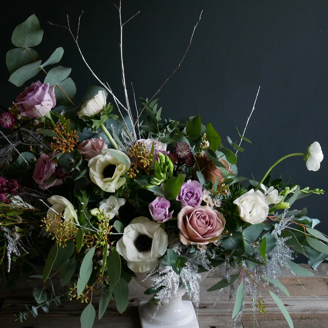 Compote design full of anemones, roses, ranunculus, foliage and ferns